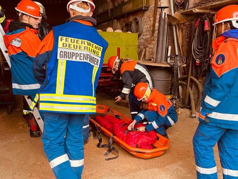 Jugendliche bei praktischer Feuerwehrübung